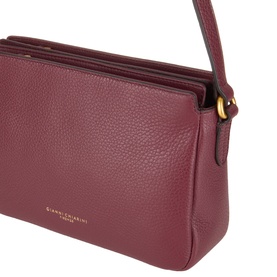 Gianni Chiarini antique ruby leather crossbody bag with gold-tone hardware, pebbled texture, and adjustable shoulder strap.
