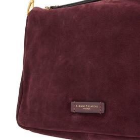 Gianni Chiarini burgundy suede crossbody bag, close-up of brand label, gold-tone zip hardware visible at top edge