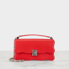 Kate Spade Deco Wavy Mini Crossbody Bag in Heirloom Tomato red leather, wavy flap silhouette, top handle, silver-tone chain strap and hardware