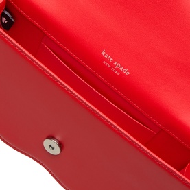 Kate Spade Deco Wavy Mini Crossbody Bag in Heirloom Tomato, interior view showing red leather lining, card slot, and silver-tone snap closure