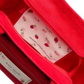 Kate Spade Dash Strawberry Canvas Tote Bag in Ruby Red, open top view showing strawberry-print pink interior lining and silver-tone hardware detail.