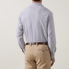 Model wearing Peter Millar black micro-check casual shirt, back view, styled with beige chinos and brown leather belt.