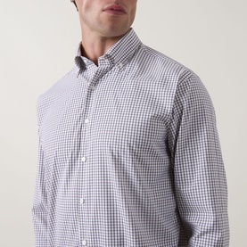 Model wearing Peter Millar black gingham casual shirt with button-down collar, shown in close-up three-quarter view.
