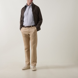 Model wearing Peter Millar black casual shirt, styled with dark brown zip jacket, beige chinos, brown belt and cream suede shoes.