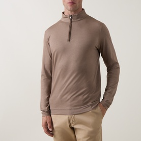 Model wearing Peter Millar Half Zip in Light Mocha, styled with beige chinos. Quarter-zip neckline, long sleeves, relaxed fit.