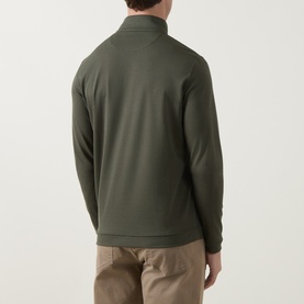Model wearing Peter Millar Half Zip in Dark Olive, rear view, styled with beige trousers