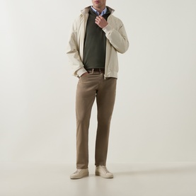 Model wearing Peter Millar Dark Olive Half Zip, styled with cream jacket, brown trousers and cream shoes.