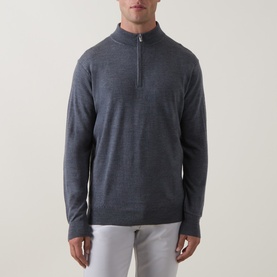 Model wearing Peter Millar Autumn Half-Zip Sweater in charcoal merino wool blend, with funnel neck and ribbed trims, styled with light grey trousers.