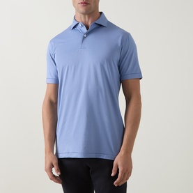 Model wearing Peter Millar Empire Performance Polo Shirt in Windy Blue, featuring spread collar, two-button placket and short sleeves, styled with