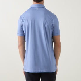 Model wearing Peter Millar Empire Performance Polo Shirt in Windy Blue, back view showing spread collar, short sleeves and straight hem