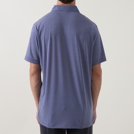 Model wearing Peter Millar polo in Bali Blue with fine white horizontal stripes, short sleeves and ribbed collar, back view.