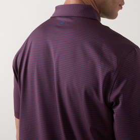 Model wearing Peter Millar polo in Navy/Bordeaux fine horizontal stripe, back collar detail visible, lightweight performance fabric.