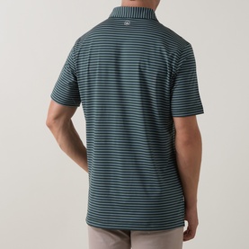 Model wearing Peter Millar polo in Pinebrook, shown from behind, featuring fine horizontal stripes and short sleeves.