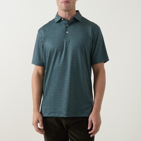 Model wearing Peter Millar polo in Pinebrook teal marl, short sleeves, three-button placket, paired with dark trousers.