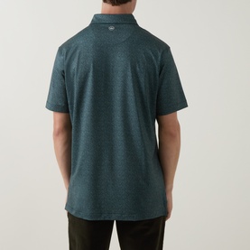 Model wearing Peter Millar polo in Pinebrook teal marl, rear view, short sleeves, paired with dark olive trousers