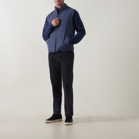 Model wearing Peter Millar navy zip-up sweat jacket with dark trousers and navy suede trainers.