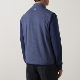 Model wearing Peter Millar navy quarter-zip sweatshirt, rear view, with contrast sleeves and subtle logo detail.