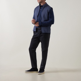 Model wearing Peter Millar navy sweatshirt with dark trousers and navy suede trainers.