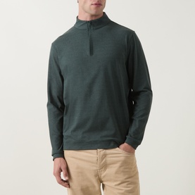 Model wearing Peter Millar Pine Brook quarter-zip sweatshirt with funnel neck, styled with beige chinos.