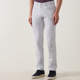 Model wearing Peter Millar eb66 Mid-Rise Straight Leg Jeans in grey, five-pocket style with belt loops, styled with navy suede loafers.