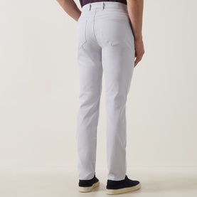 Model wearing Peter Millar eb66 Mid-Rise Straight Leg Jeans in grey, five-pocket style with logo patch, styled with navy slip-on shoes.