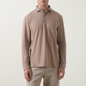 Model wearing Peter Millar long-sleeve polo shirt in Sawgrass, styled with light beige trousers