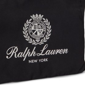 Ralph Lauren black bag close-up showing embroidered crest logo and Ralph Lauren New York script branding in silver-white