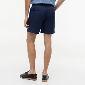 Model wearing Tommy Hilfiger Carbon Navy shorts, back view, styled with dark leather boat shoes.