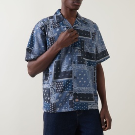 Model wearing Dickies dark navy patchwork bandana-print short-sleeve camp collar shirt, styled with dark jeans.