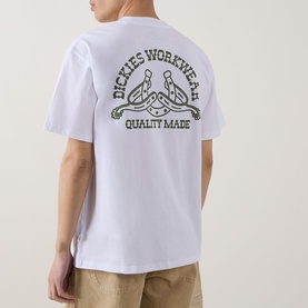 Model wearing Dickies Bettsville Logo T-Shirt in white, showing back graphic with Workwear Quality Made slogan, styled with beige trousers.