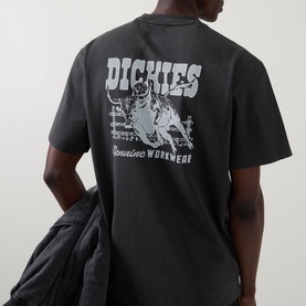 Model wearing Dickies Buchtell Logo T-Shirt in black, showing back graphic print with Dickies branding and workwear illustration.