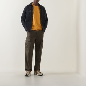 Model wearing Dickies Sunflower Crew Neck T-shirt, styled with dark denim jacket, olive cargo trousers and beige trainers.