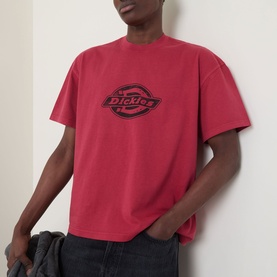 Model wearing Dickies Crew Neck T in Garnet with large tonal logo print on chest, styled with dark jeans.