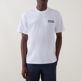 Model wearing Dickies white crew neck T-shirt with small chest logo print, styled with navy trousers.