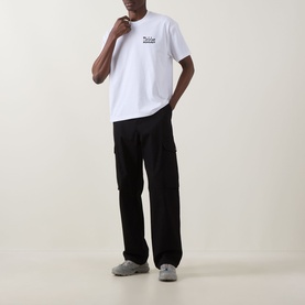 Model wearing Dickies white crew neck T-shirt with small chest logo, styled with black cargo trousers and grey trainers.