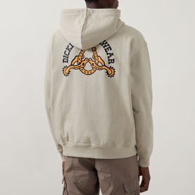 Model wearing Dickies Bettsville Logo Zip Hoodie in Eucalyptus, rear view showing branded gear graphic print, styled with cargo trousers.