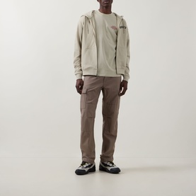 Model wearing Dickies Bettsville Logo Zip Hoodie in Eucalyptus with cargo trousers and trail trainers