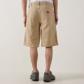 Model wearing Dickies 958 Loose Denim Shorts in Eucalyptus, rear view showing back pocket logo detail, styled with grey trainers.