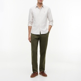 Model wearing Tommy Hilfiger Coastal Taupe stripe shirt with olive chinos and brown leather lace-up shoes.