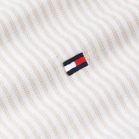 Tommy Hilfiger menswear fabric close-up in Coastal Taupe stripe with embroidered flag logo detail.