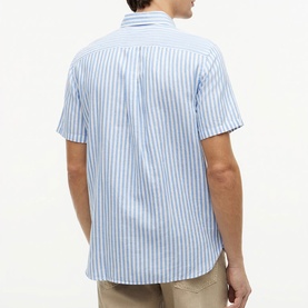 Model wearing Tommy Hilfiger short-sleeve shirt in Blue Spell stripe, shown from the back, with button-down collar detail.
