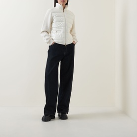 Model wearing Moncler natural cardigan with quilted front panels, styled with dark wide-leg trousers and black chunky boots