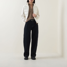 Model wearing Moncler Natural cardigan with dark wide-leg jeans, brown top, black belt and black shoes.