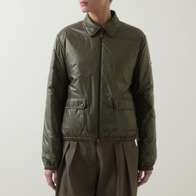 Model wearing Moncler olive quilted padded jacket with collar, front flap pockets and zip fastening, styled with brown wide-leg trousers