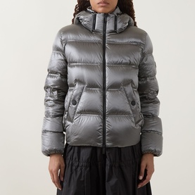 Model wearing Moncler dark grey hooded puffer jacket with zip fastening and side pockets, styled with black wide-leg trousers