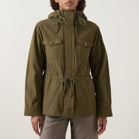 Model wearing Moncler olive parka with hood, drawstring waist, zip front and chest flap pockets, styled with grey trousers