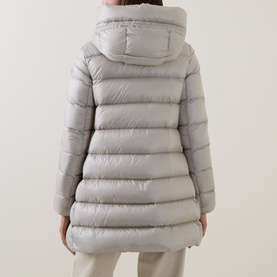 Model wearing Moncler cream quilted down parka, rear view, with hooded collar and mid-length silhouette