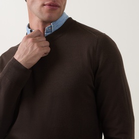 Model wearing Paul Smith brown merino wool crew neck jumper, styled with a light blue collared shirt underneath.