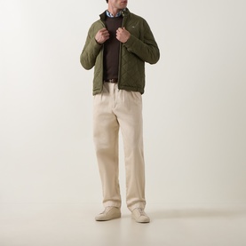 Model wearing Paul Smith Brown Merino Wool Crew Neck jumper, styled with olive zip-up jacket and cream trousers.