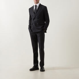 Model wearing Paul Smith Charcoal Formal Trousers in wool-cashmere blend, styled with matching double-breasted jacket, white shirt and black tie.